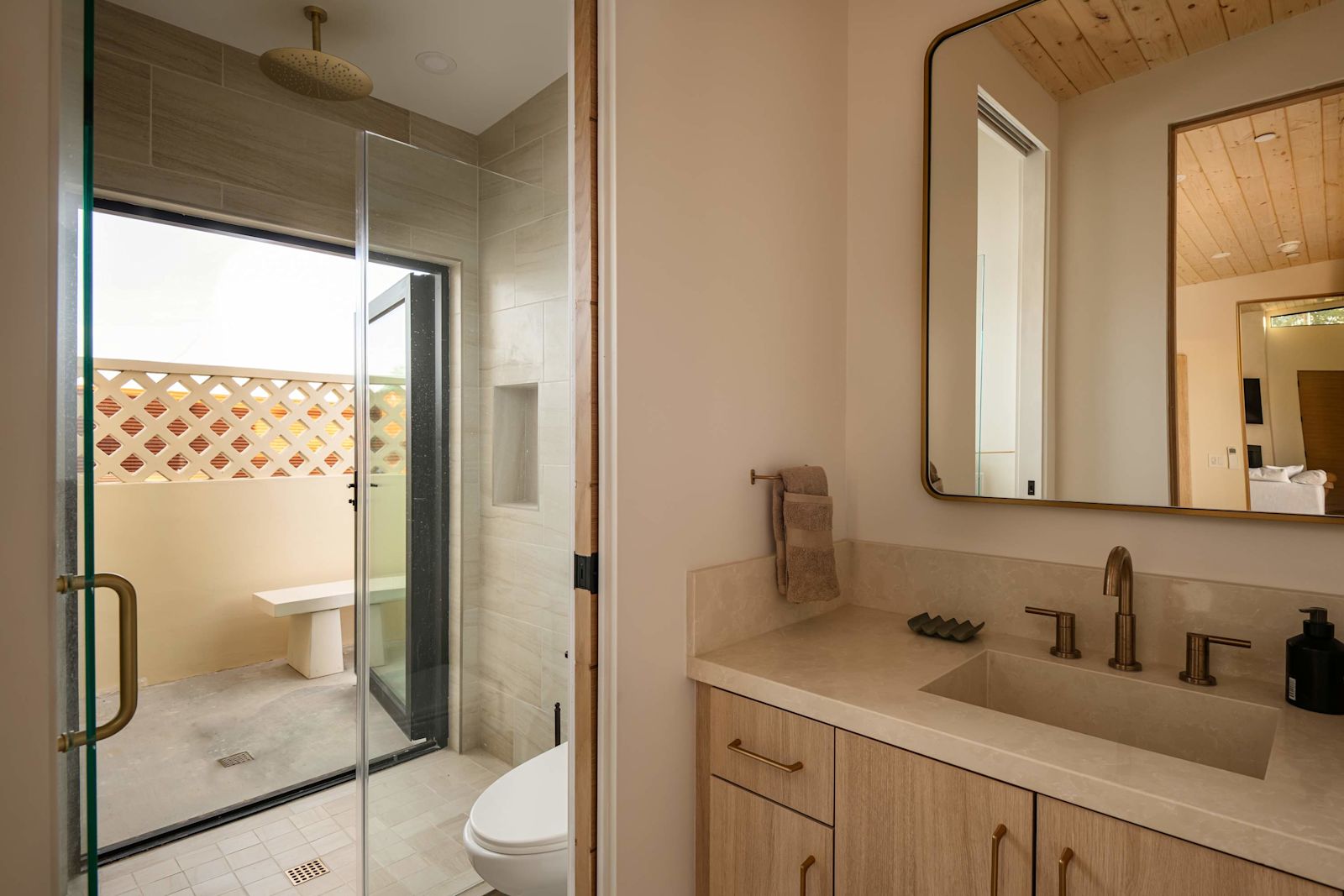 Bathroom with rain shower opening to a private courtyard