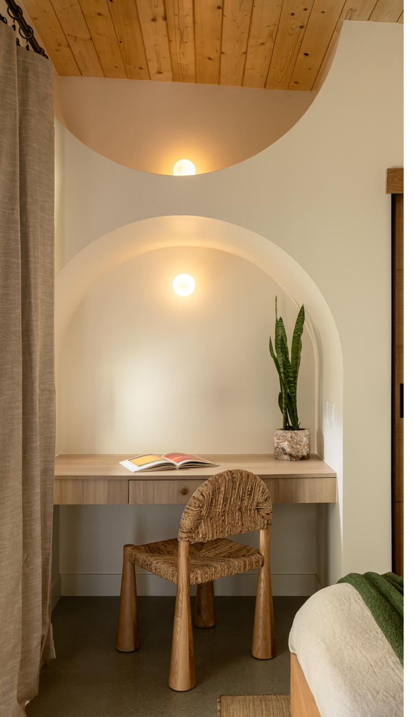 Bedroom workspace nook with arched alcove and warm light